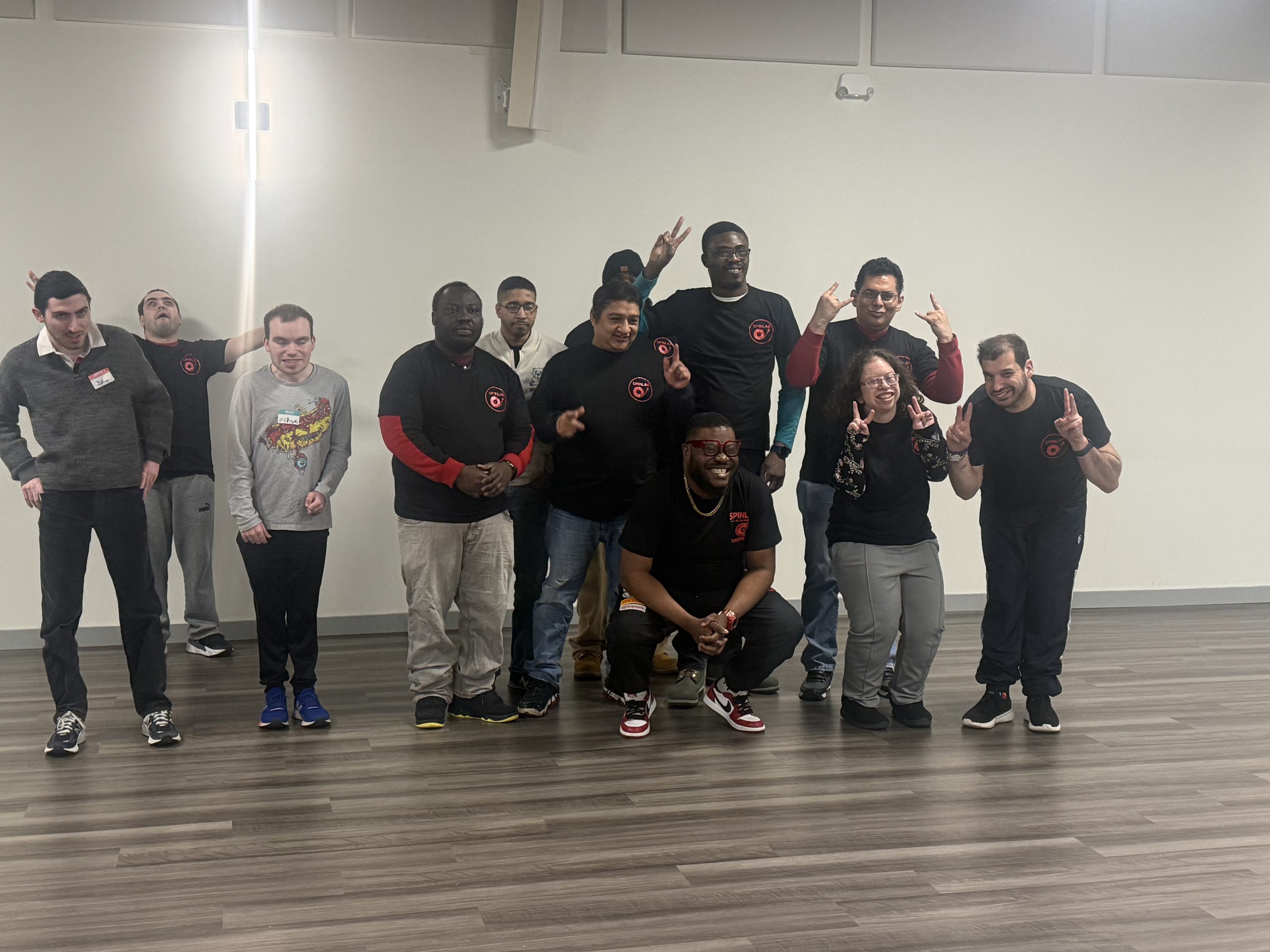 SpinLab DJ Academy students holding certificates after completing a group DJ class